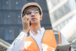 Asia engineer man working with walkie talkie at rooftop construction site   