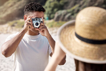 Poster - Man, camera and photography with woman at beach, couple on holiday for travel and memory together. Honeymoon, date or anniversary getaway with retro tech for picture taking and adventure outdoor