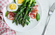 Fresh Asparagus and Prosciutto Salad Served With Boiled Eggs and Microgreens