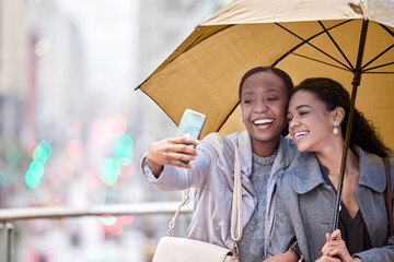 Wall Mural - Woman, friends and phone for selfie in rain, outdoor and together, relax and picture on vacation, summer and update for social media. Smile, people and hug, love and holiday, bonding and memory