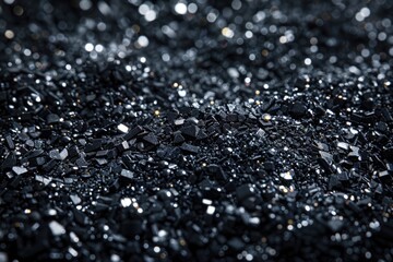 Sticker - A pile of black rocks with a shiny surface