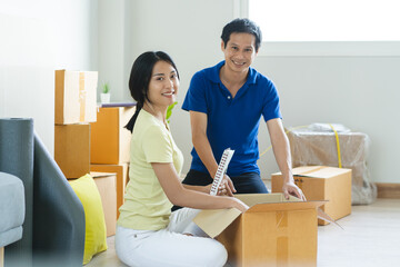 Asian couple lover unpacking thing after relocation to new apartment.