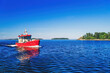 Red boat in the archipelago on a beautiful sunny summer day
