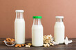 Set or collection of various vegan milk almond, coconut, cashew, on table background. Vegan plant based milk and ingredients, top view
