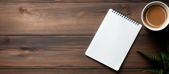 Poster - A copy space image of a notebook styled with a tablet and coffee placed on a wooden surface