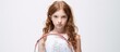© HN Works - A young girl holding a tennis racket poses against a clean white background with ample copy space for use in design or advertisements