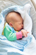 Newborn baby boy in hospital cot