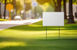 © Oksana - Blank yard sign on green grass. Yard sign mockup in the park near the walking path