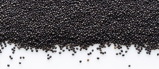 Sticker - Top view of black quinoa seeds on a white background with ample space for your text in the image