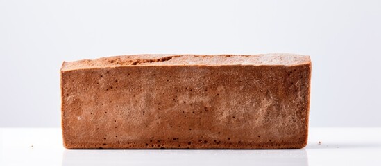Aufkleber - A copy space image of a rye flour bread brick with spices placed on a white background