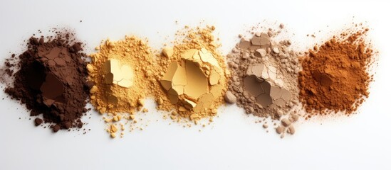 Poster - The golden highlighting powders are displayed on a white background creating a striking contrast The white backdrop provides ample copy space for the image to shine