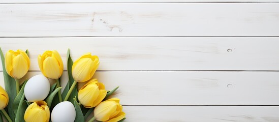 Aufkleber - Copy space image of vibrant Easter eggs and yellow tulips arranged on a backdrop of white wooden planks