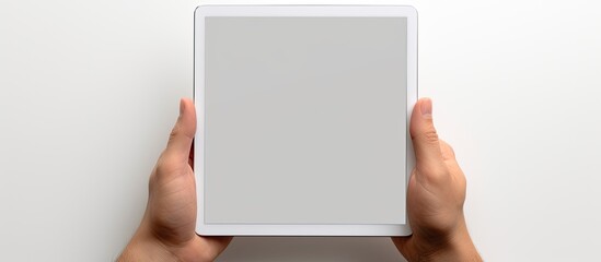 Poster - A white background with a hand holding a tablet PC featuring a blank screen to insert an image. Creative banner. Copyspace image