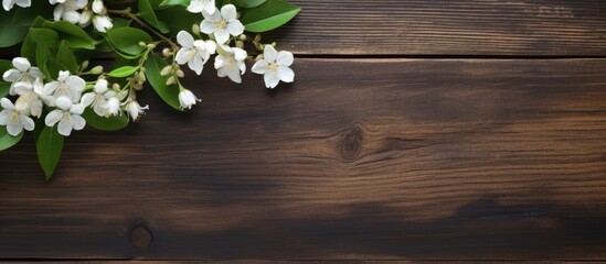 Poster - A copy space image of jasmine tea adorned with fragrant jasmine flowers set against a rustic wooden background