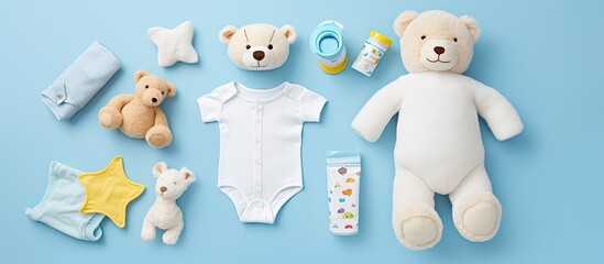Poster - An assortment of baby items including cloth diapers baby powder a nibbler cream a teether a soother and a baby toy arranged on a blue background The image includes copy space and is viewed from the t