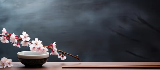 Poster - A copy space image featuring chopsticks placed on a wooden table alongside a sakura bowl