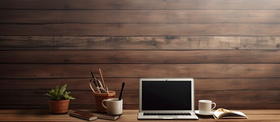 Fototapete - A wooden office desk with a laptop a cup of coffee and various supplies Copy space image