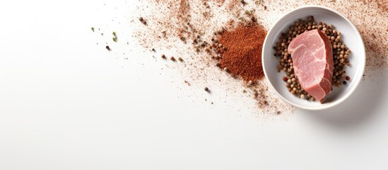 Poster - Copy space image of a ceramic plate with flakes spices on a white putty background featuring raw organic pork fillet perfect for grilling baking or frying