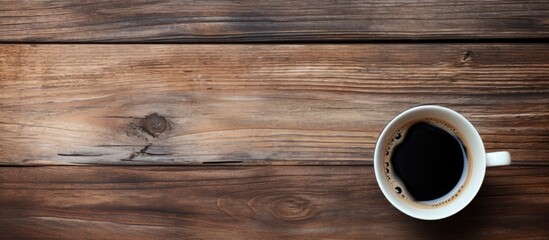 Aufkleber - A top down perspective showing an old wooden surface with a cup of black coffee perfect for a copy space image 108 characters