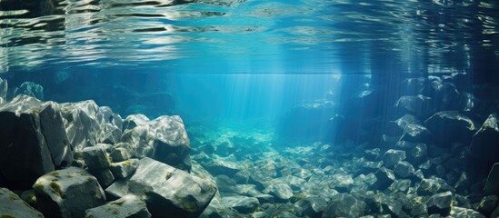 Poster - Underwater rocks create an abstract water texture in this image providing ample copy space