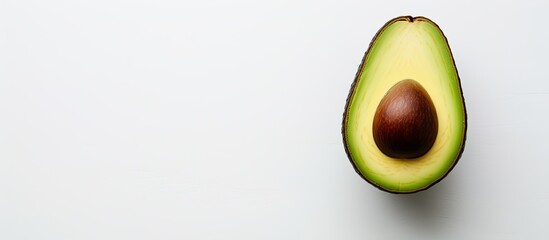 Poster - A top view of a whole avocado on a light background with a frame that provides space for text. Creative banner. Copyspace image