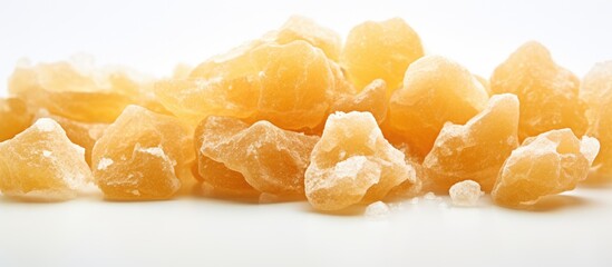 Wall Mural - A macro photo of crystallized ginger with a shallow depth of field on a white background providing copy space