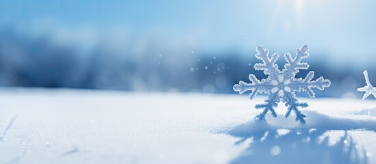 Fototapete - A snowflake with a blue hue stands out against the white snow on a snowy background creating a visually striking image with plenty of copy space