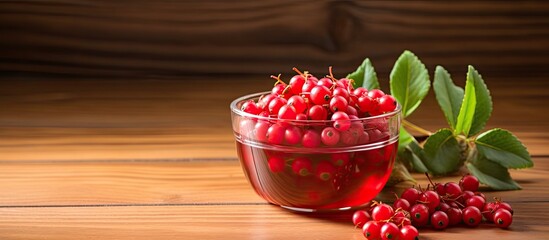 Poster - A revitalizing cocktail of honeysuckle berries is displayed in a small bowl against a natural wood background providing plenty of space for adding text. Creative banner. Copyspace image