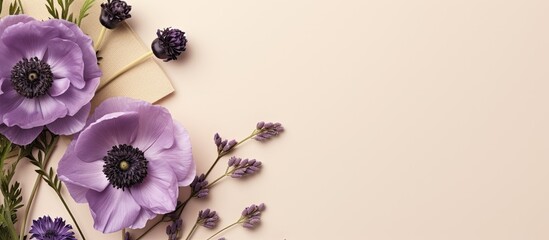 Leinwandbilder - Top view flatlay of a beige background with a purple flower anemone envelope and greeting card mockup The card mockup features copy space