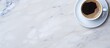 © HN Works - A copy space image of a coffee cup can be seen from a top view position on a marble table background