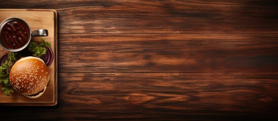 Poster - The image shows a burger from a top view on a wooden table accompanied by a black tray offering ample empty space for creative purposes
