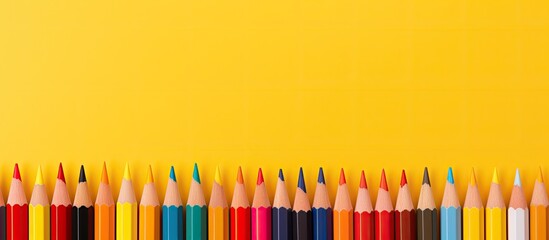 Aufkleber - A banner displaying colored pencils on a yellow background perfect for a school or creative painting theme The image provides ample copy space