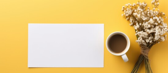 Poster - Yellow background with a flat lay of a mockup paper blank accompanied by a coffee cup and a bouquet of herbs flowers Ample copy space is available