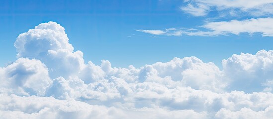 A picturesque copy space image featuring a serene blue sky background adorned with fluffy white clouds