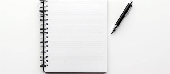 Fototapete - A copy space image of a pen and notebook set against a white background
