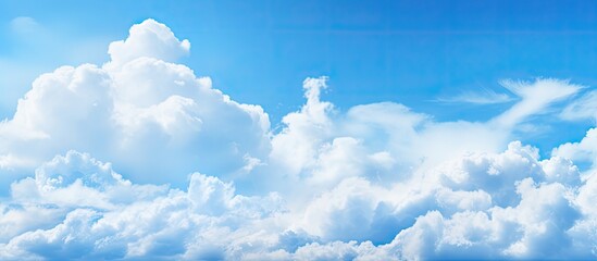 Aufkleber - A copy space image of fluffy white clouds against a vivid blue sky