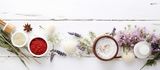 Poster - A copy space image of herbal flowers adorns a white wooden table showcasing a selection of cosmetic creams lip balm soap and bath salt