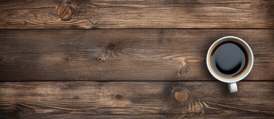 Aufkleber - A top down perspective showing an old wooden surface with a cup of black coffee perfect for a copy space image 108 characters