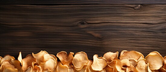 Wall Mural - An organic natural food consisting of dried apple chips is beautifully presented in a close up top view on a brown wooden table creating a visually appealing copy space image