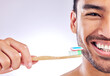 Portrait, man and smile with toothpaste in studio background for dental hygiene, cleanliness and wellness. Male person, happy with toothbrush for mouth odor, freshness and healthcare or whitening