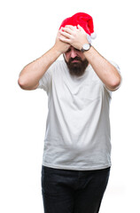 Wall Mural - Young caucasian hipster man wearing christmas hat over isolated background suffering from headache desperate and stressed because pain and migraine. Hands on head.