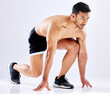 Asian man, start or runner in studio for exercise, fitness training or cardio workout on white background. Topless, set or athlete ready for sports performance, sprinting race or running competition