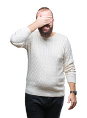 Sticker - Young caucasian hipster man wearing winter sweater over isolated background smiling and laughing with hand on face covering eyes for surprise. Blind concept.