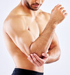 Muscular man, elbow and bone with pain from accident, fall or injury on a white studio background. Closeup of male person or bodybuilder with sore arm, muscle or joint from tension or inflammation