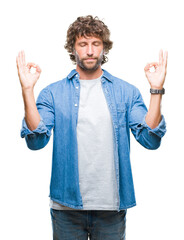 Sticker - Handsome hispanic model man over isolated background relax and smiling with eyes closed doing meditation gesture with fingers. Yoga concept.