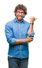 Poster - Handsome hispanic model man wearing glasses over isolated background smiling with happy face looking and pointing to the side with thumb up.