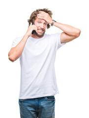 Wall Mural - Handsome hispanic man model talking on smartphone over isolated background stressed with hand on head, shocked with shame and surprise face, angry and frustrated. Fear and upset for mistake.