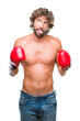 © Krakenimages.com - Handsome hispanic boxer man wearing boxing gloves over isolated background sticking tongue out happy with funny expression. Emotion concept.