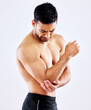 Muscular man, elbow and bone with injury or pain from accident or fall on a white studio background. Frustrated male person or bodybuilder with sore arm, muscle or joint from tension or inflammation