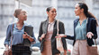 © peopleimages.com - Discussion, city and business women walking on commute, travel and journey in conversation. Professional, corporate team and people in urban town talking for planning, communication and networking
